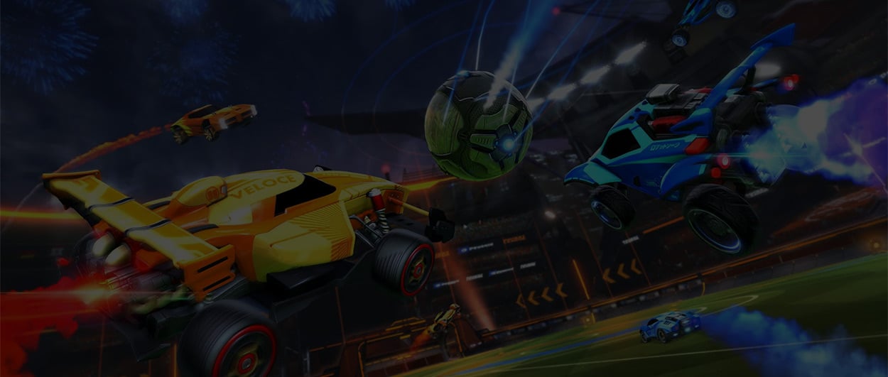 Three cars from Rocket League flying through the air towards a moving ball, with a fourth car driving on the.